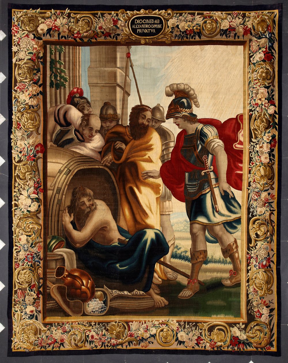 Diogene i Aleksander: spotkanie greckiego filozofa Diogene de Sinope (413-327 p.n.e.) w jego beczce z królem Aleksandrem Wielkim (356-323 p.n.e.) w Koryncie. Kiedy zdobywca zapytał go, czego chce, Diogene odpowiedział: "Zdejmij trochę z mojego słońca". Kra autorstwa Belgian School
