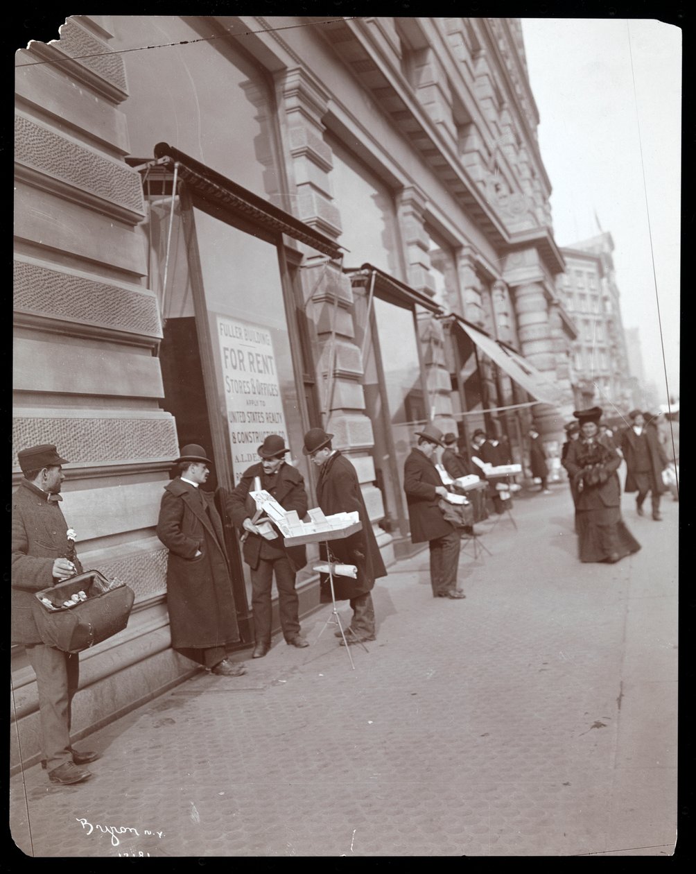 Widok handlarzy sprzedających zabawki i inne przedmioty przed Fuller lub Flatiron Building na Broadwayu, 5th Avenue i 23rd Street, Nowy Jork, ok.1895 (srebrny odbitka żelatynowa) autorstwa Byron Company