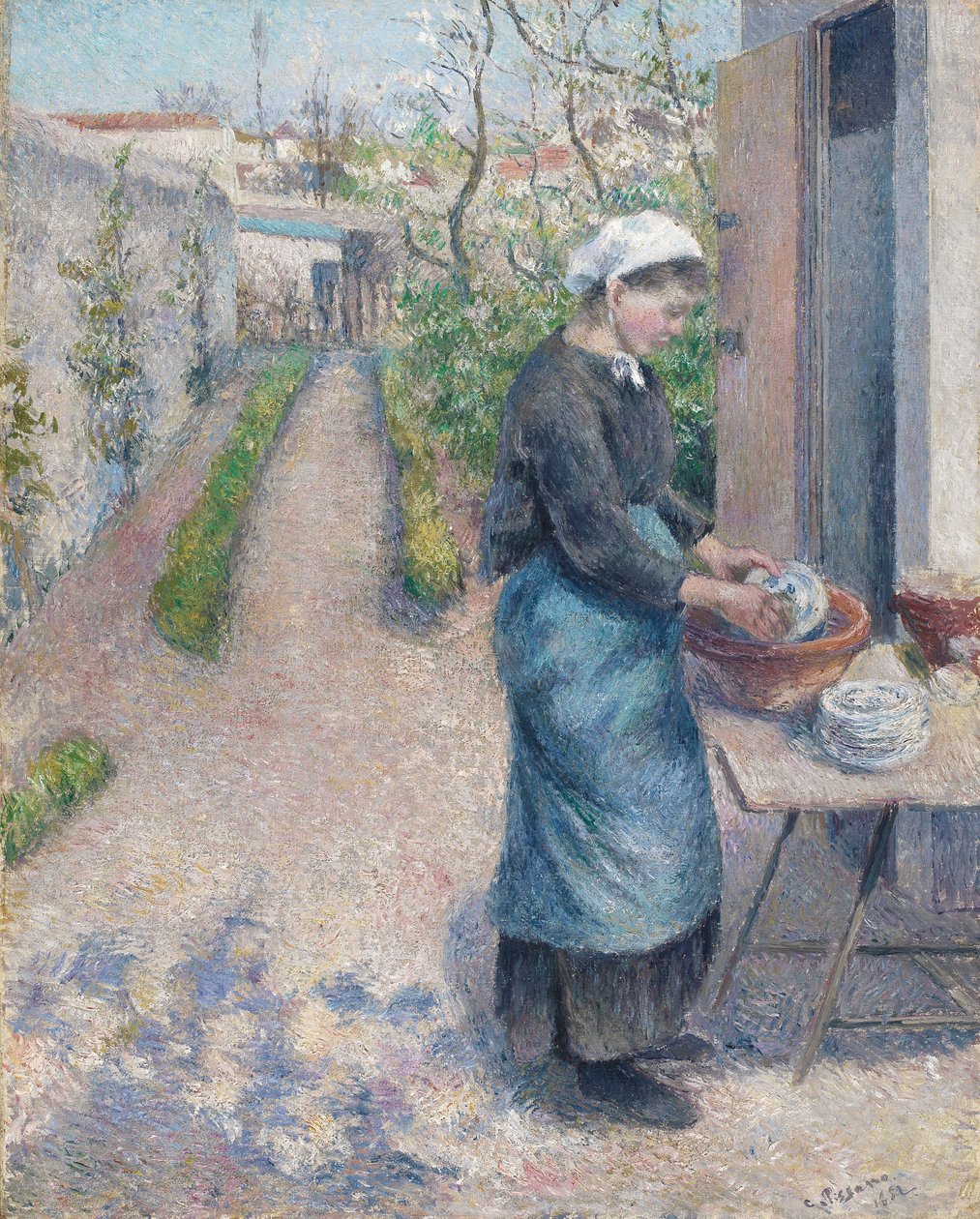 W ogrodzie w Pontoise: Młoda kobieta zmywająca naczynia, 1882 autorstwa Camille Jacob Pissarro