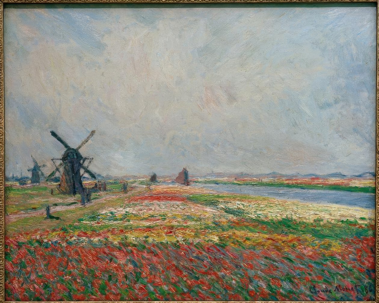 Pola kwiatów i wiatraki w pobliżu Leiden autorstwa Claude Monet