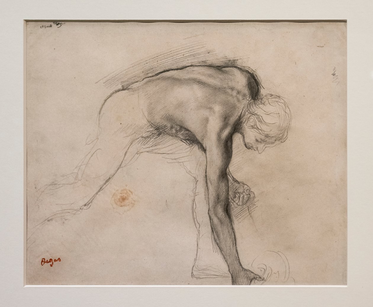 Nagi mężczyzna pochylony, podnosząc przedmiot. Około 1859-1861. Grafit na papierze welinowym. autorstwa Edgar Degas
