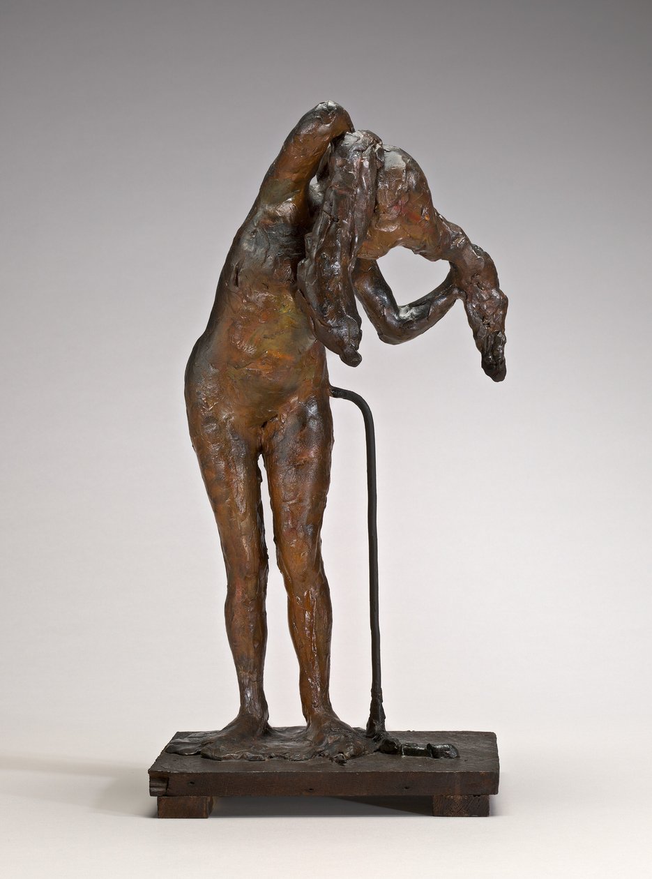 Kobieta układająca włosy, prawdopodobnie późne lata 1880-1890. autorstwa Edgar Degas