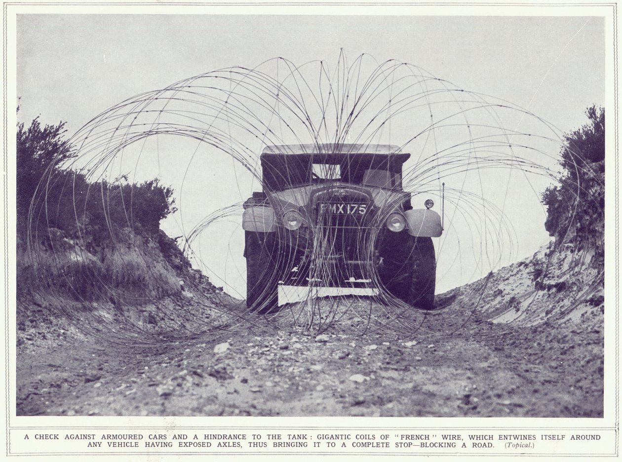 Samochód pancerny zostaje zatrzymany przez gigantyczne zwoje francuskiego drutu blokujące drogę, z The Illustrated War News, opublikowanej 22 listopada 1939 autorstwa English Photographer