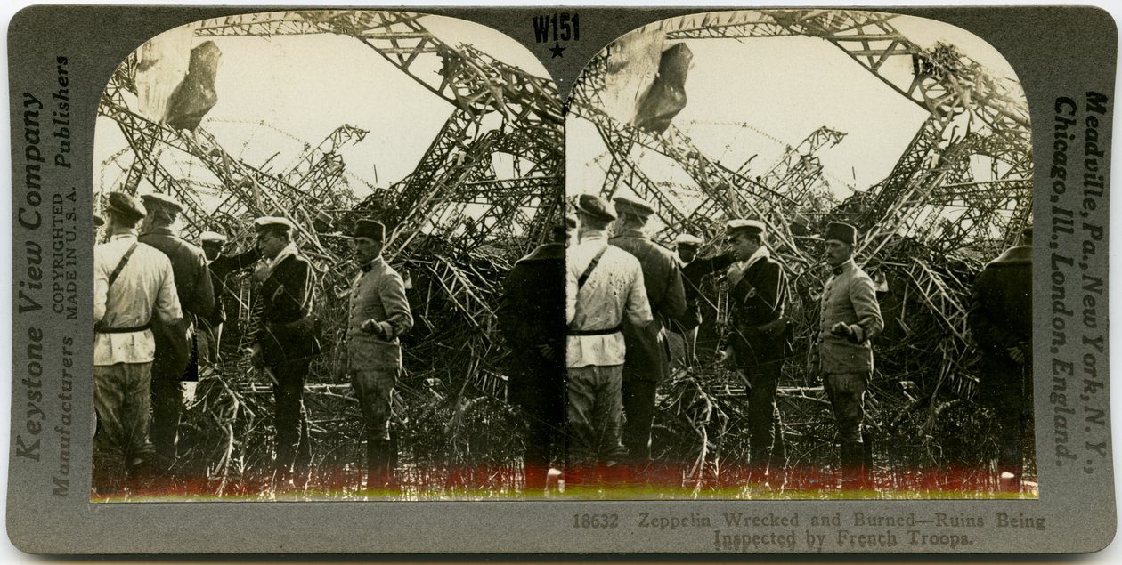 Pozioma stereokarta w sepii przedstawiająca grupę umundurowanych mężczyzn przeglądających wrak sterowca. Stereograf Keystone numer 18632. Tytuł brzmi autorstwa Keystone View Company