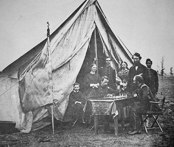 Pułkownik James P. McMahon z rodziną i przyjaciółmi gra w szachy w dowództwie 164. Nowojorskiego Pułku Piechoty (zdjęcie czarno-białe) autorstwa Mathew Brady