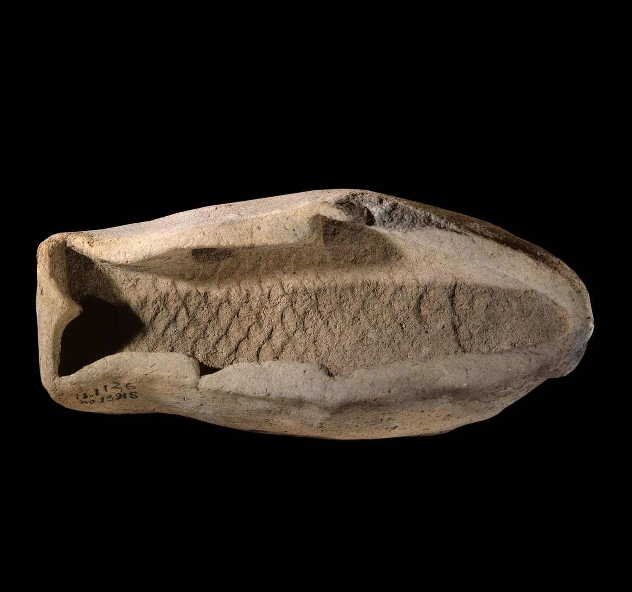 Mezopotamie: pleśń z terakoty w kształcie ryby. Około 1800 r. p.n.e. Z królewskich potraw Pałacu Króla Zimri Lima w Mari. Paryż, Luwr autorstwa Mesopotamian