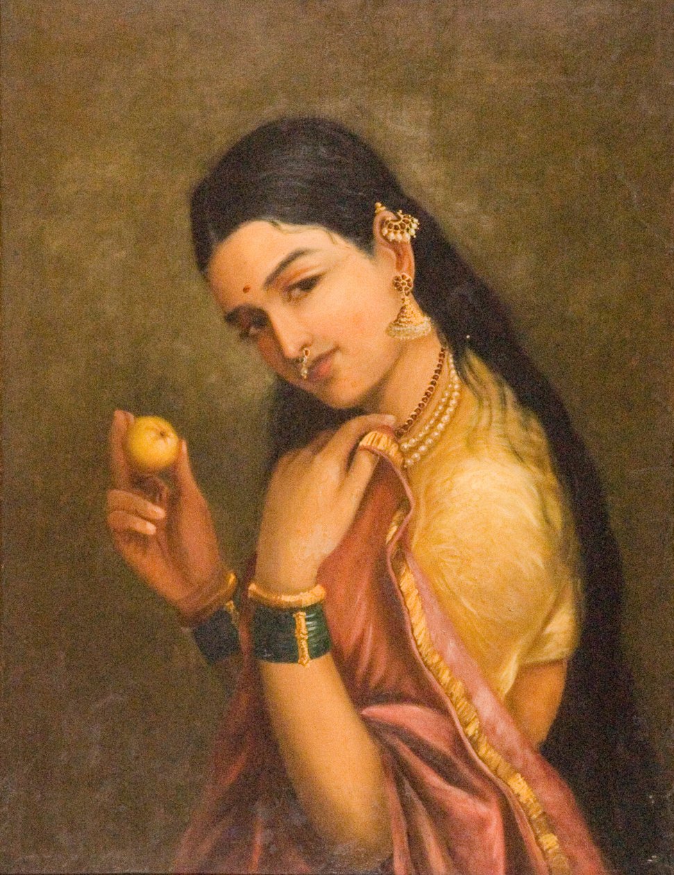 Kobieta trzymająca owoc autorstwa Raja Ravi Varma