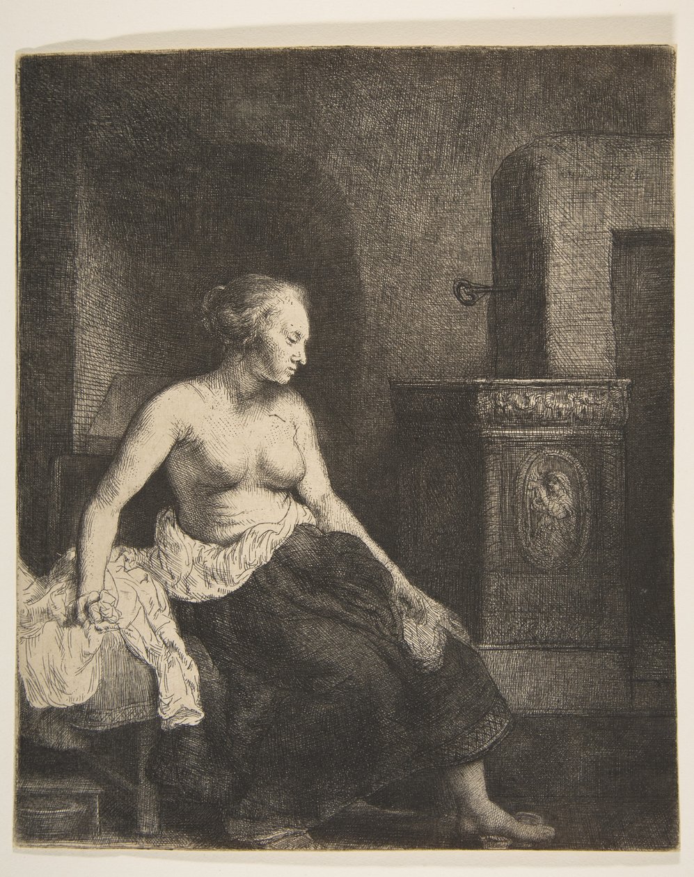 Kobieta siedząca na wpół ubrana obok pieca, 1658. autorstwa Rembrandt van Rijn