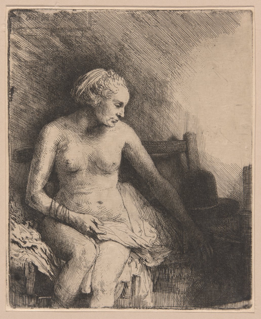 Kobieta w wannie z kapeluszem obok niej autorstwa Rembrandt van Rijn