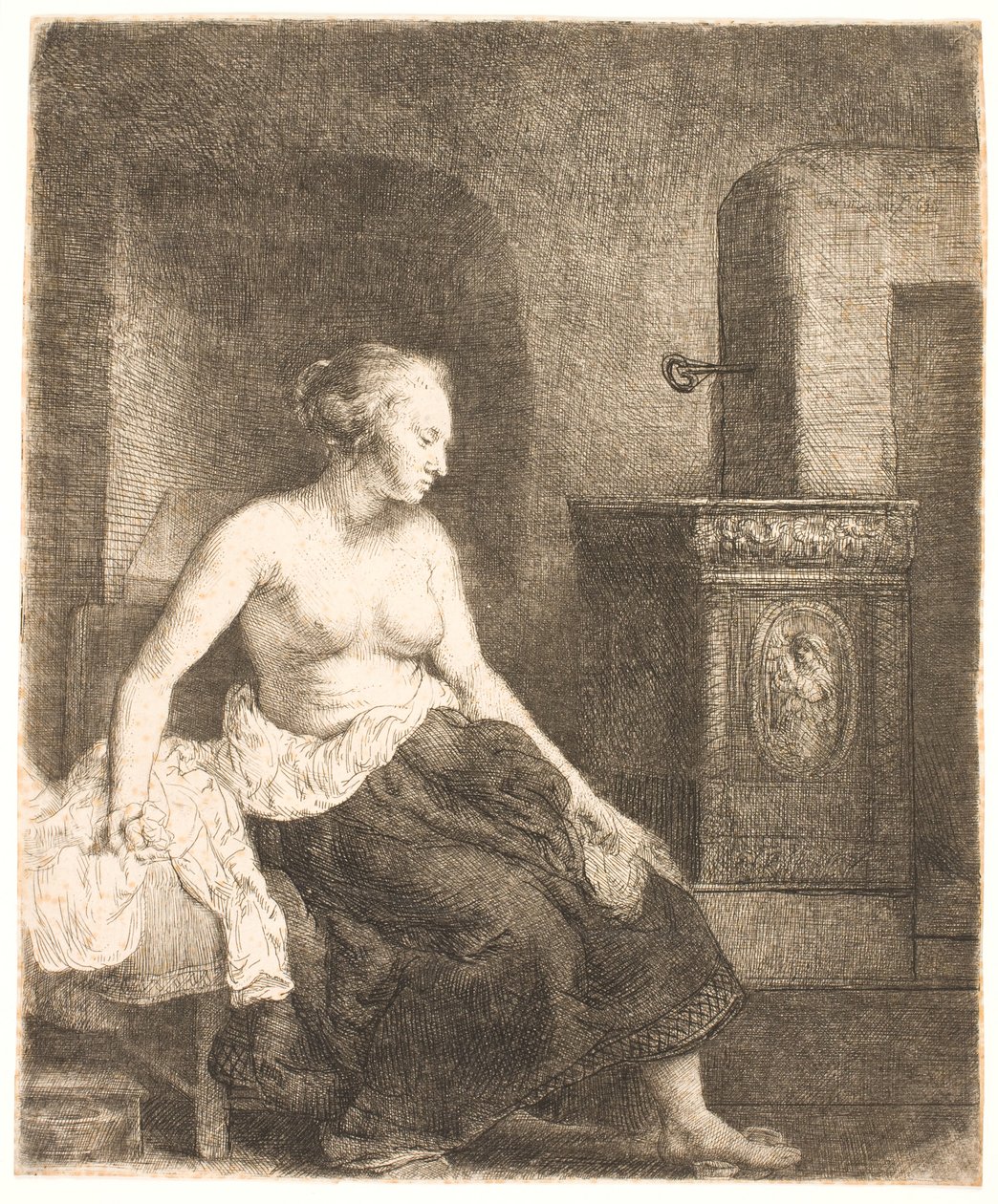 Kobieta siedzi na wpół ubrana obok pieca autorstwa Rembrandt van Rijn