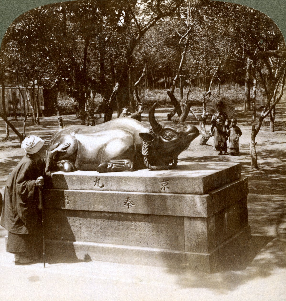 Pobożna kobieta głaszcząca brązowego byka leczyć reumatyzm, świątynia Kitano Tenjin, Kioto, Japonia, 1904 autorstwa Underwood and Underwood