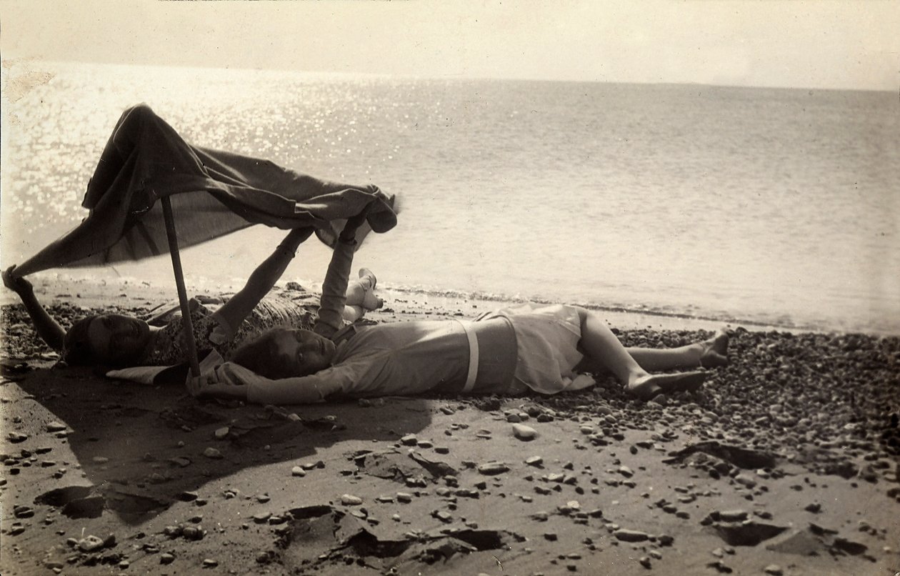 Dwie kobiety leżące na brzegu morza w cieniu ręcznika. Pocztówka wysłana przez fotografa do Vincenzo Balocchi autorstwa Vincenzo Balocchi