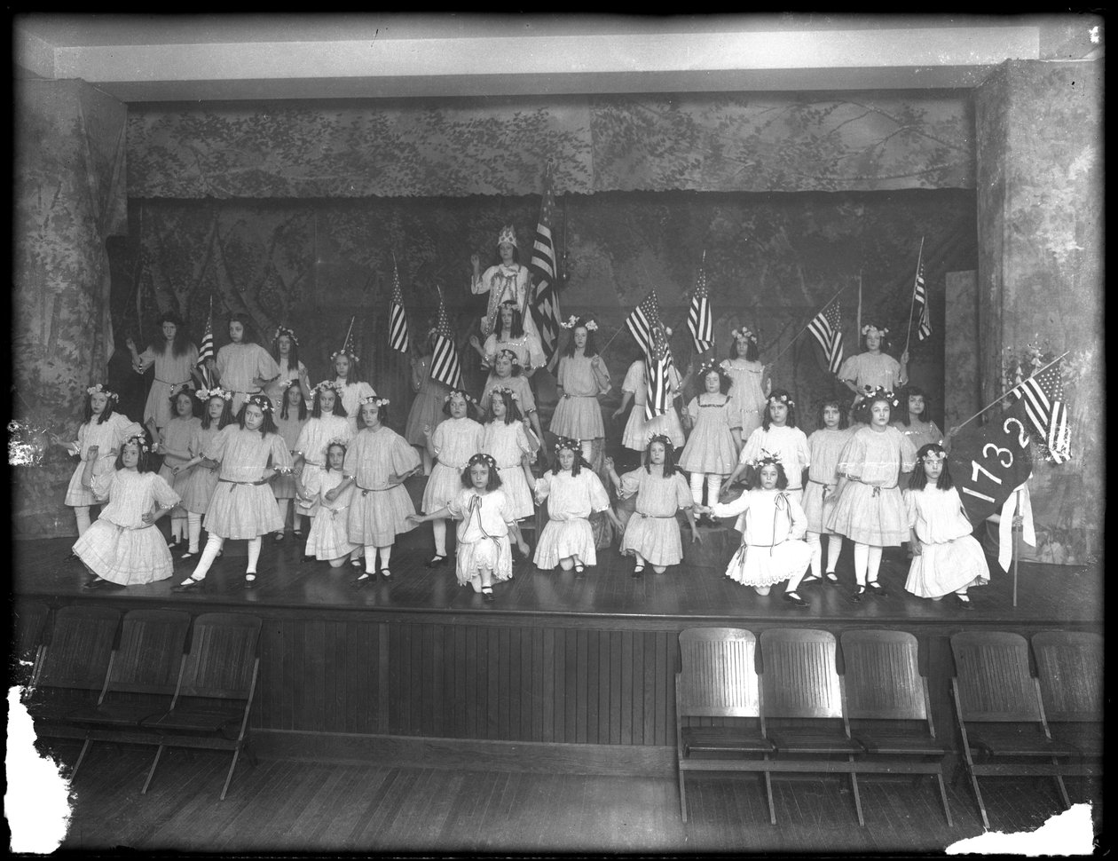 Portret grupowy małych dziewczynek podczas przedstawienia, prawdopodobnie w Roman Catholic Orphan Asylum, Kingsbridge, Bronx, ok. 1911 r. autorstwa William Davis Hassler