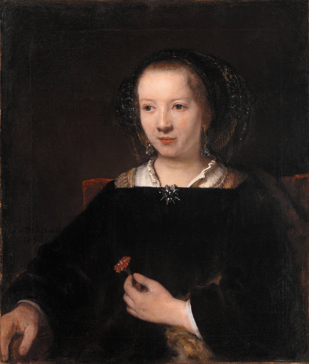 Młoda kobieta z goździkiem autorstwa Workshop of Rembrandt van Rijn