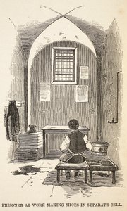 Więzień przy pracy przy robieniu butów w oddzielnej celi, ilustracja z The Criminal Prisons of London i Scenes from Prison Life Henry