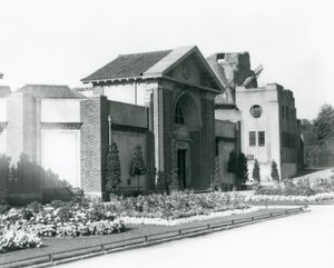 Reptile House w londyńskim zoo w 1928 roku z formalnymi klombami wzdłuż ścieżek prowadzących do wejścia (zdjęcie czarno-białe) autorstwa Frederick William Bond