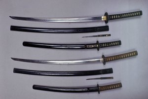 U góry: katana, japoński miecz z pochwą, wakizashi, japoński krótki miecz w pochwie, mały sztylet Kokatawa schowany w tej samej pochwie. wszystkie trzy pochodzą z XVIII wieku. niższe pochodzą z XVII wieku. autorstwa Japanese School
