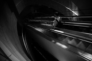 Samotna wędrówka w górę schodami ruchomymi autorstwa Satoshi Hata