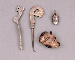 Różne elementy aparatury i klejnoty wikingów, w prawym górnym rogu przedstawienie bóstwa Odyna. Sztokholm, Historiska Museet