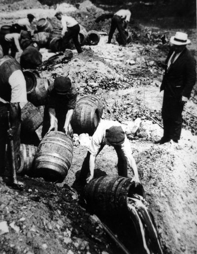 Amerykański agent federalny nadzoruje niszczenie beczek piwa podczas amerykańskiej prohibicji (1920-33) (zdjęcie czarno-białe) autorstwa American Photographer