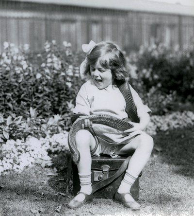 Młoda dziewczyna Betty trzymająca wschodniego węża indygo, siedząca na skórzanym bagażniku, londyńskie zoo, 1924 autorstwa Frederick William Bond