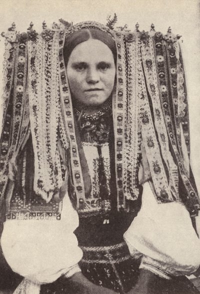 Czeszka w nakryciu głowy z wstążek, gdzie każda wstążka oznacza zalotnika, którego odmówiła w małżeństwie (zdjęcie czarno-białe) autorstwa Photographer Czech