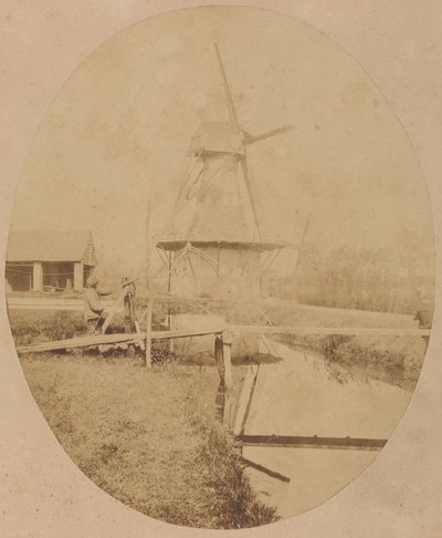 [Malarz w kapeluszu przy sztalugach malujący wiatrak]. autorstwa Unknown artist
