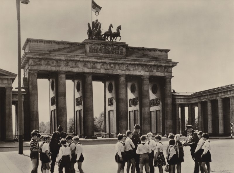 Pionierzy Yong przybywają do Bramy Brandenburskiej, symbolu Berlina, aby zobaczyć swoich przyjaciół, strażników granicznych (zdjęcie czarno-białe) autorstwa Photographer German