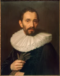 Portret mężczyzny trzymającego rękawiczki, lekko w lewo