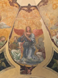 Modlący się anioł między dwoma klęczącymi muzykami i cherubinami