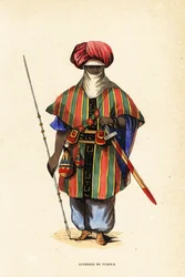 Szlachetny wojownik Tuaregów z Agadez, Niger, w tagelmust (turban i welon), taktkat (koszula) i akarbej (spodnie)