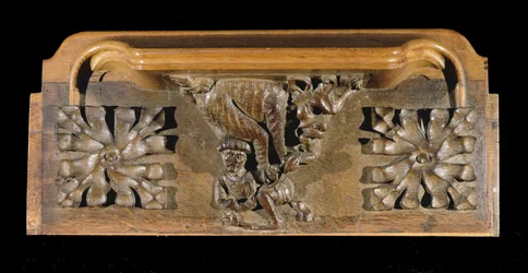 Mizerykorda przedstawiająca małą postać w czapce, na którą napadł potwór, New College Chapel, Oxford, koniec XIV wieku (drewno)