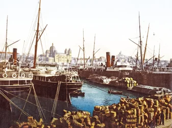 Beczki z winem i łódki na nabrzeżu w Marsylii z katedrą marsylską w tle, pub. 1890-1900