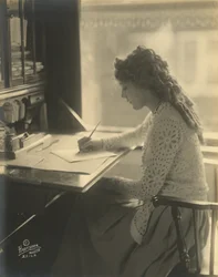 Mary Pickford pisze przy biurku, ok. 1918 (zdjęcie czarno-białe)