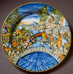 Epizod z obrony mostu Sublicjusza przez legendarnego rzymskiego bohatera Horacjusza Koklesa podczas walk z Etruskami. Ceramiczny talerz wykonany w Urbino w warsztacie Fontana we Włoszech. Około 1560. Florencja, Museo Nazionale del Bargello