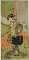 Aktor Yamashita Kinsaku II jako Miyagino przebrany za fryzjera w sztuce Kosode-gura no Tekubari, wystawionej w Teatrze Morita w drugim miesiącu, 1772 (?)