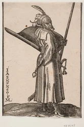 Żołnierz stojący (akinci), profil do r.; w r. maczuga, w. r. w ręce lanca, której wierzchołek znajduje się poza górną linią obramowania; z prawej strony tarcza z wnętrzem zwróconym do góry, z prawej strony miecz