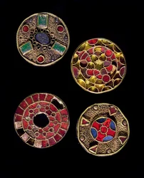 Archeologia średniowiecza. Sztuka barbarzyńska Galii: fibule, od łacińskiego fibula, oznaczającego zapinkę, w złotych i srebrnych pracach filigranowych, styl polichromowany. Francja, okres merowiński, VI-VII wiek. Strasburg, Musée d