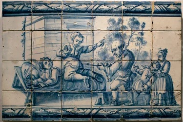 Lekarz wykonujący pacjentowi lewatywę - Panel satyryczny z Lizbony, pierwsza połowa XVIII wieku (Lekarz - Panel satyryczny, pierwsza połowa XVIII wieku) - Narodowe Muzeum Azulejos, Lizbona (Portugalia)