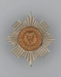 Kepurės ženklelis, apie 1896-1920 (metalo)polis