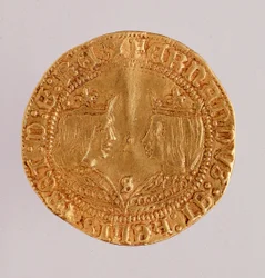 Złota moneta z Hiszpanii: panowanie króla katolickiego Ferdynanda i Izabeli (Ferdynanda II Aragońskiego i Izabeli I Kastylii). 1474-1516 śr. 2,7 cm Neapol, muzeum archeologiczne