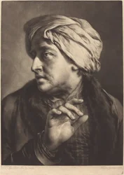 Mężczyzna w turbanie i koszuli w paski