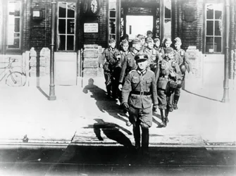 Oficer armii niemieckiej prowadzący swoją firmę na peron stacji kolejowej, Paryż, sierpień 1940