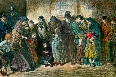 Ubóstwo w Londynie u drzwi schroniska. Biedne i głodne rodziny ustawiają się w kolejce przed przytułkiem. Rycina z 1869 roku. Kolekcja prywatna