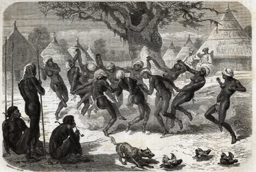 Taniec powitalny wykonywany przez kobiety z plemienia, po powrocie Bakera i jego żony z Lake Albert (Albert Nyanza). Engravure pour illustration le voyage au lac Albert, en 1861-1864, de Sir Samuel White Baker, w „Le tour du monde, nouveau journal des voya
